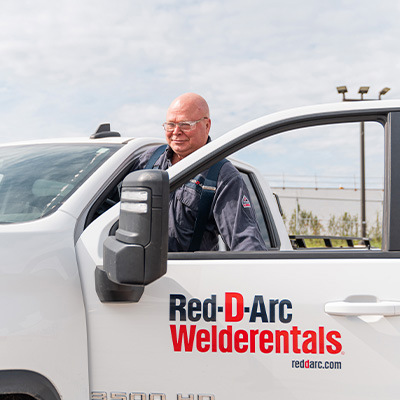Employee climbing into company truck to make a delivery