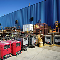 Used welders lined up in a warehouse yard