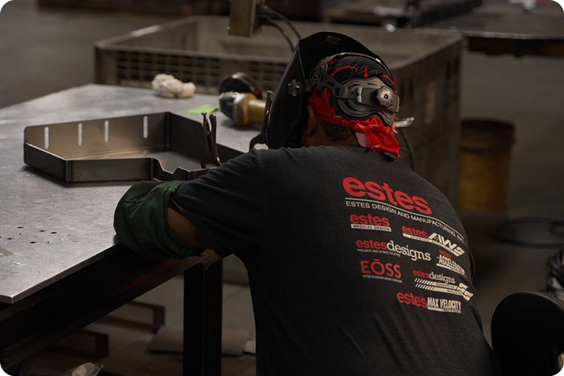 Welder working in shop at manufacturing facility