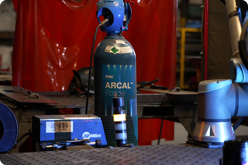 ARCAL gas cylinder in a dark workshop