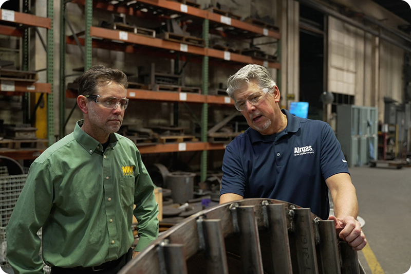 Employee showing customer piece of equipment