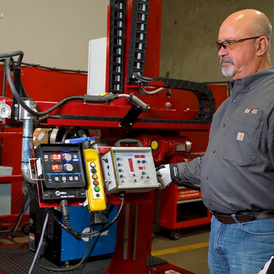 Employee operating weld automation equipment