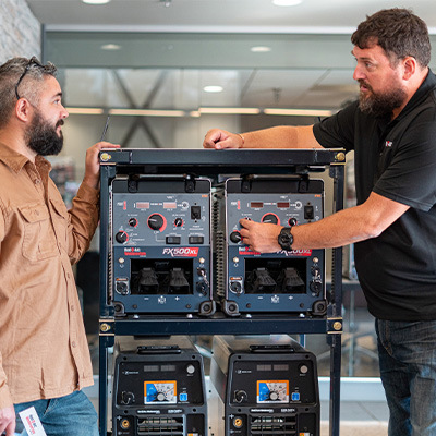 Employee showing customer welding equipment in Ontario Rental Centre