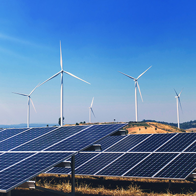 A sunny day featuring solar panels and wind turbines, symbolizing clean and sustainable energy sources