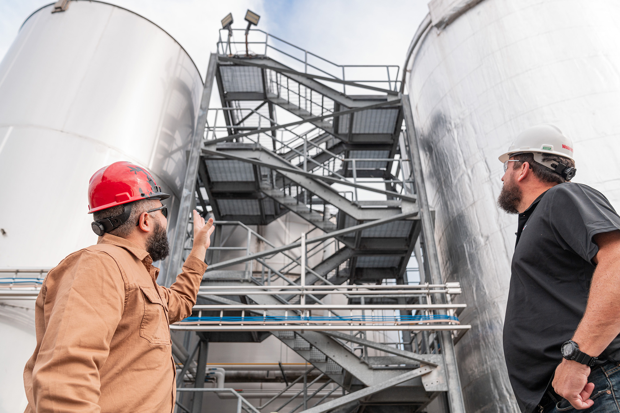 Employee and customer inspecting manufacturing facility