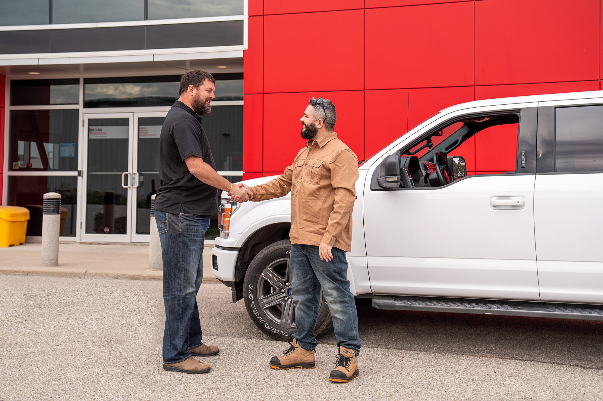 Employee shaking customer's hand in front of Ontario Rental Centre