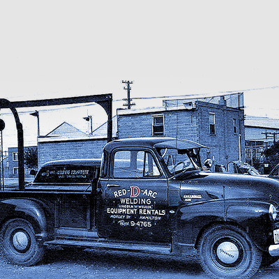 Vintage Red-D-Arc truck parked in front of original Red-D-Arc storefront