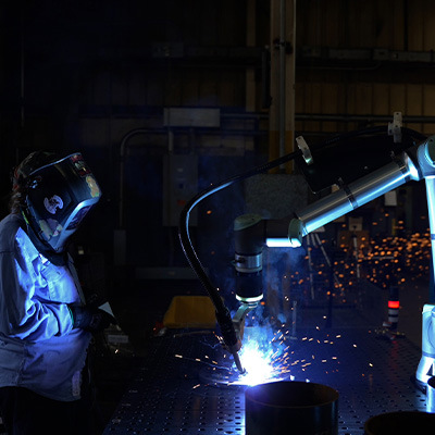 BotX cobot welding system in action as operator observes weld