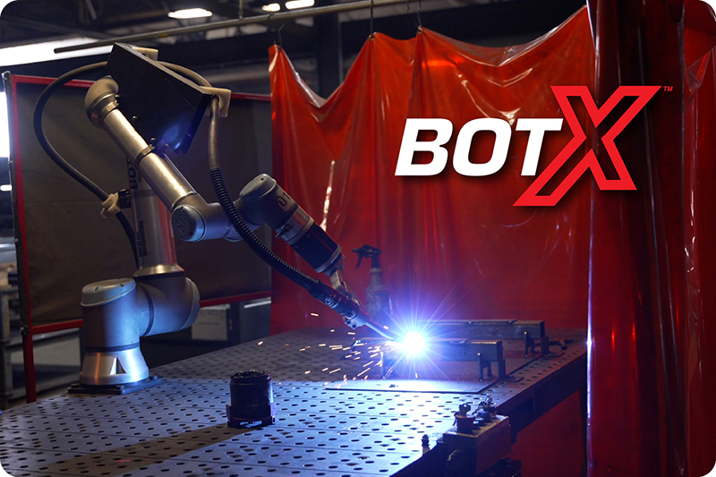 BotX cobot welding system performing a weld in a dark workshop
