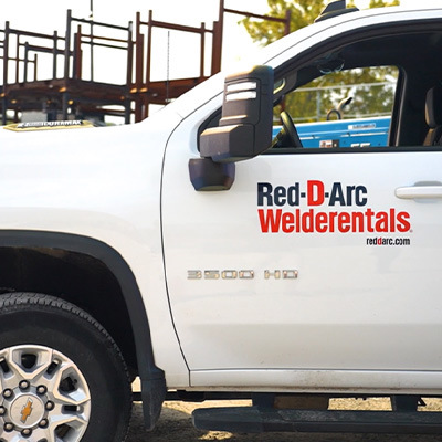 Red-D-Arc branded company truck on construction site