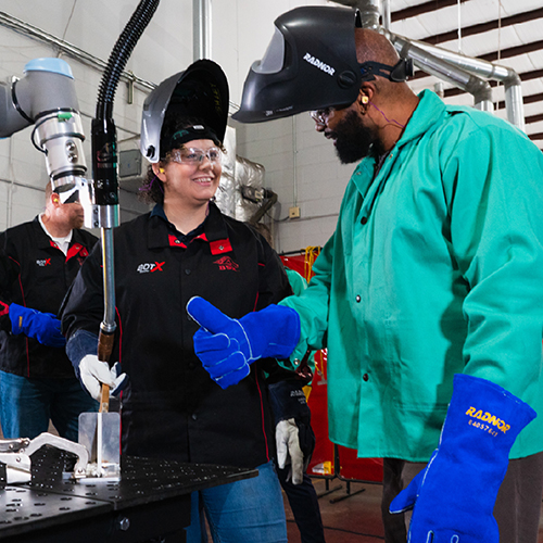 Red-D-Arc employees doing a demo of the BotX system