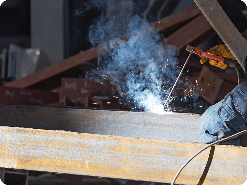 a person using a stick welder