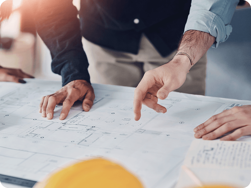 a group of people reviewing plans on a table