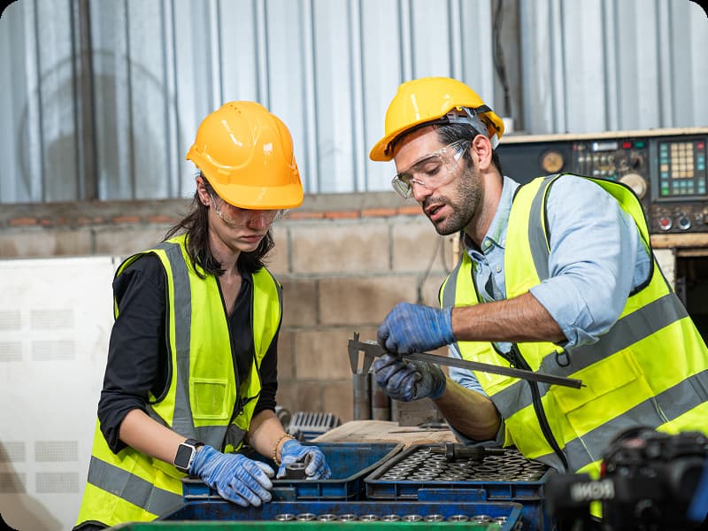 man and women measuring pipe