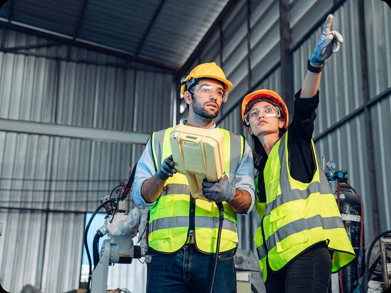 woman directing man on equipment use
