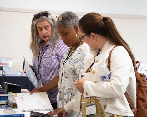 Conference attendees looking at materials