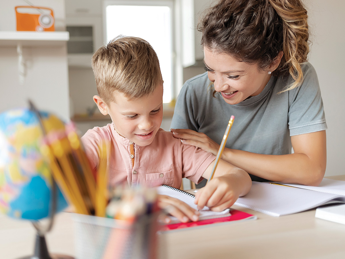 a mother helping her son with writing