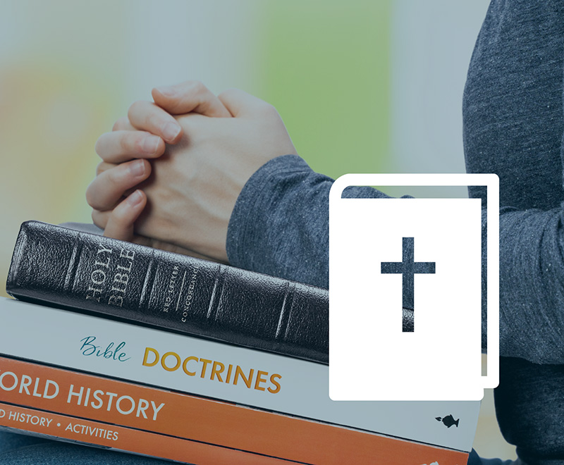 a student with a stack of textbooks and a Bible