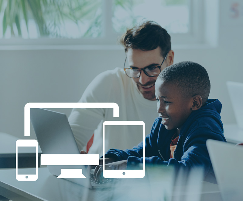 a man and boy working on a computer