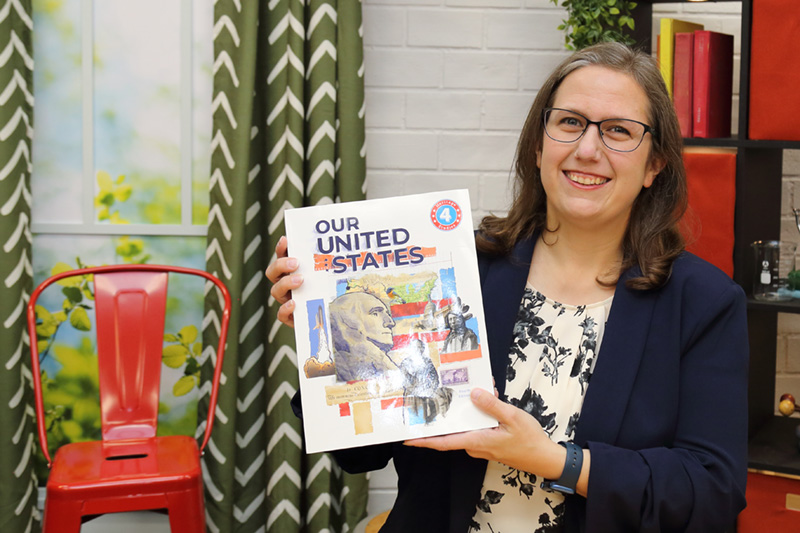 the teacher showing the textbook