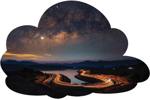 a photo of the night sky with stars above and a road with streaks of light below