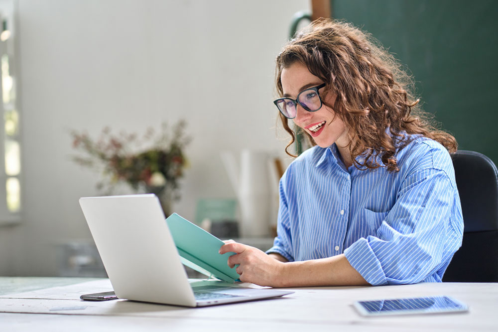 a teacher working on a laptop